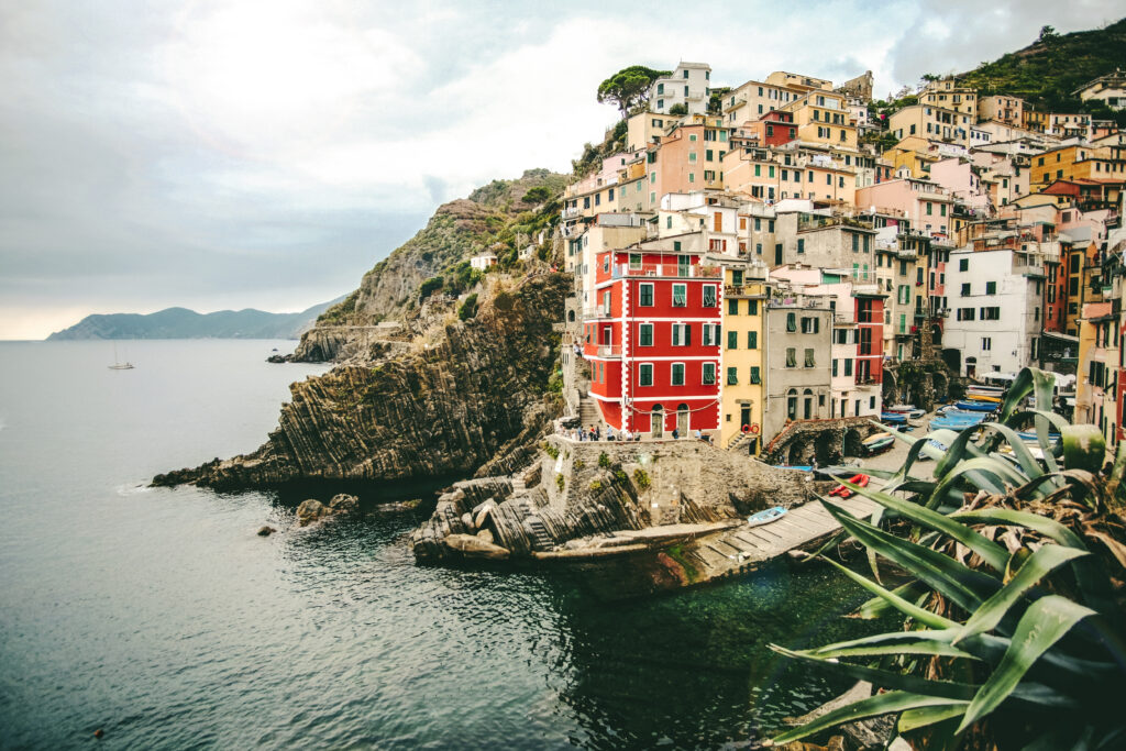 https://guideupstudyabroad.com/wp-content/uploads/2025/05/beautiful-shot-assorted-color-buildings-hill-near-sea-manarola-italy-1024x683-1.jpg